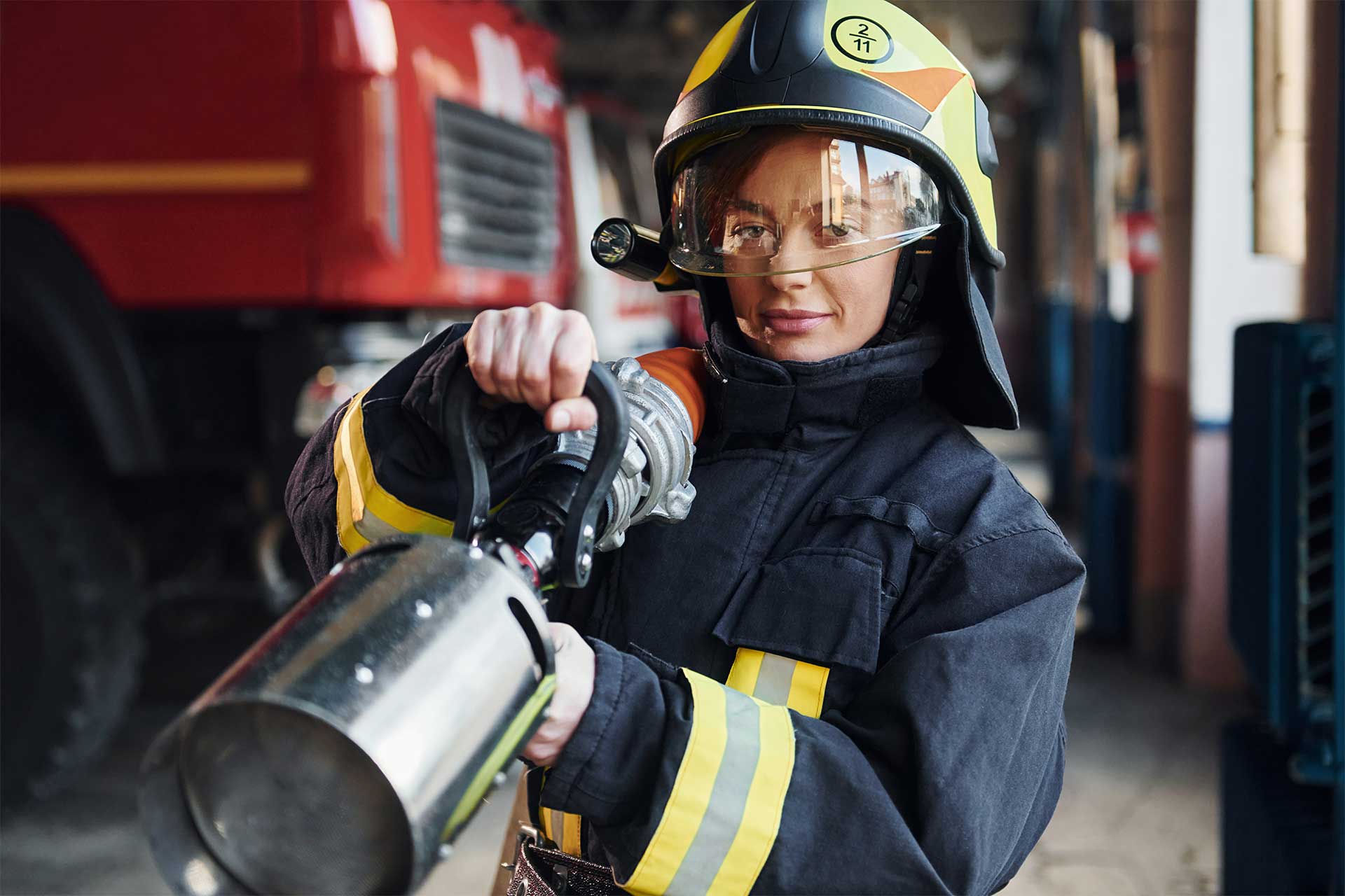 hose-in-hands-female-firefighter-in-protective-un-2023-11-27-04-53-28-utc.jpg